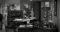 Fig. 6-7: 13 Ghosts: Castle’s office in the film’s introduction, and Cyrus Zorba’s office from the second scene of the film’s narrative. Though it would have been inaccessible to first-time viewers of the film in 1960, the shots of Castle in his office also contain a clever inside joke. On the walls are framed portraits – not of people per se, but of several of the thirteen titular ghosts that appear in later scenes of the film.