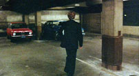 Fig. 8: At the beginning of the film, The Driver steals a blue Ford for his getaway car rather than the red BMW parked beside it.