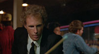 Fig. 9: Bracketed by men red and blue clothing, The Detective is introduced shooting pool in a bar decorated by red and blue neon.