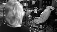 Fig. 13: Claudia finds Sandro making love to Gloria Perkins on a couch in the hotel lounge.