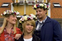 Trille (Anne Grethe Bjarup Riis), Kalle (Janus Dissing Rathke) og Palle (Anders W. Berthelsen) foran familiens gulmalede svenske træhus. Credit: FOTO: Ole Kragh-Jacobsen/Græsted Film & Fjernsyn.